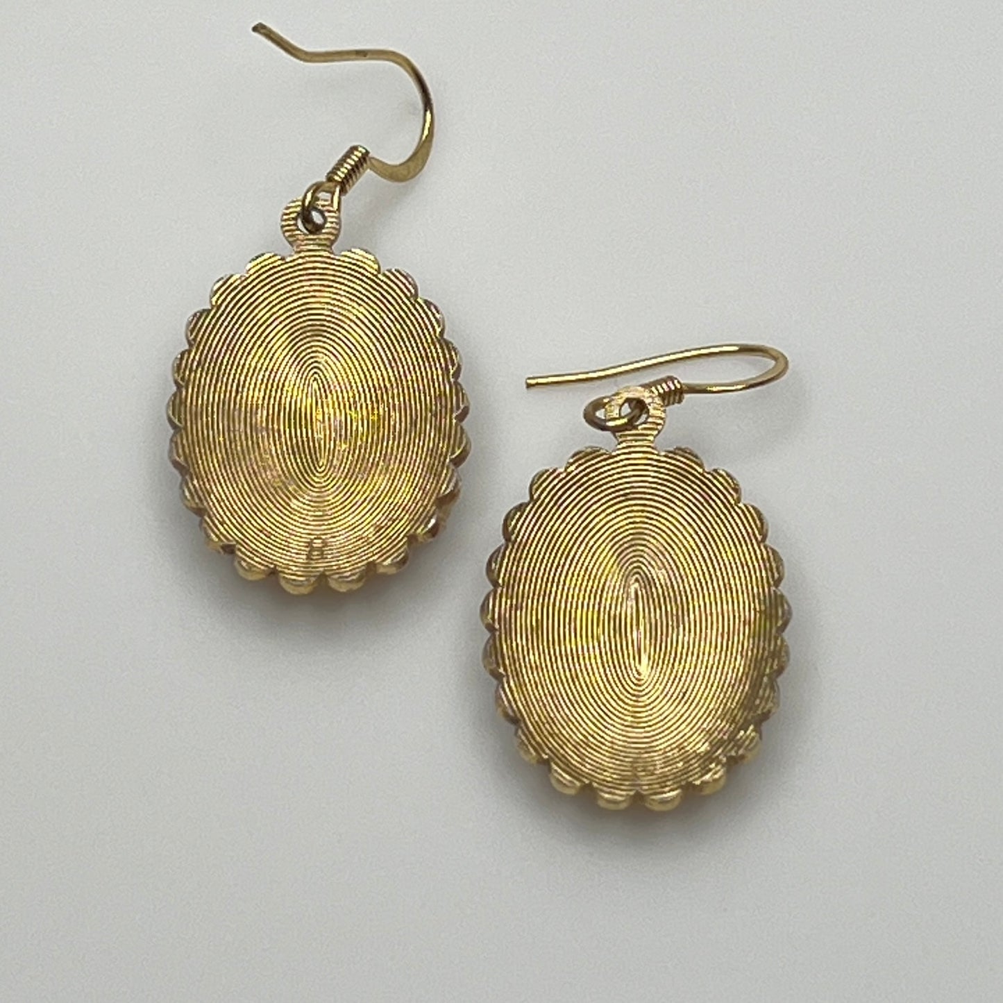 Gold-tone vintage dangle earrings with blue and clear rhinestones, ornate etched design