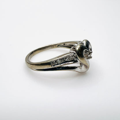 Side view of 10K white gold heart ring with diamond-set shoulders