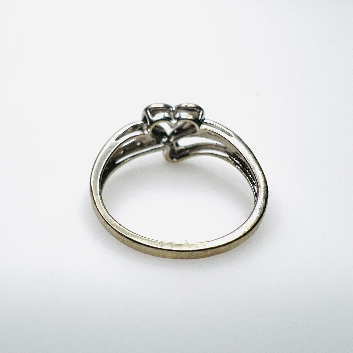 Side view of 10K white gold heart ring with diamond-set shoulders