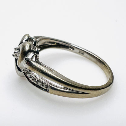 Side view of 10K white gold heart ring with diamond-set shoulders