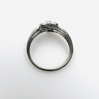 Top view of 10K white gold heart ring with diamond-set shoulders