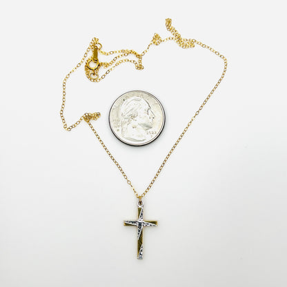 Vintage gold-filled cross necklace beside quarter showing petite pendant scale