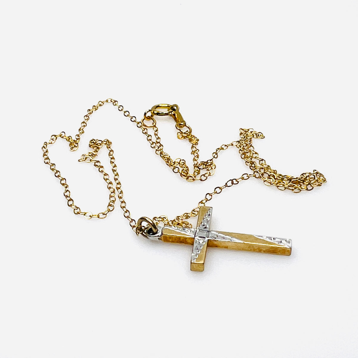 Side view of vintage Carl-Art gold-filled cross pendant and delicate chain