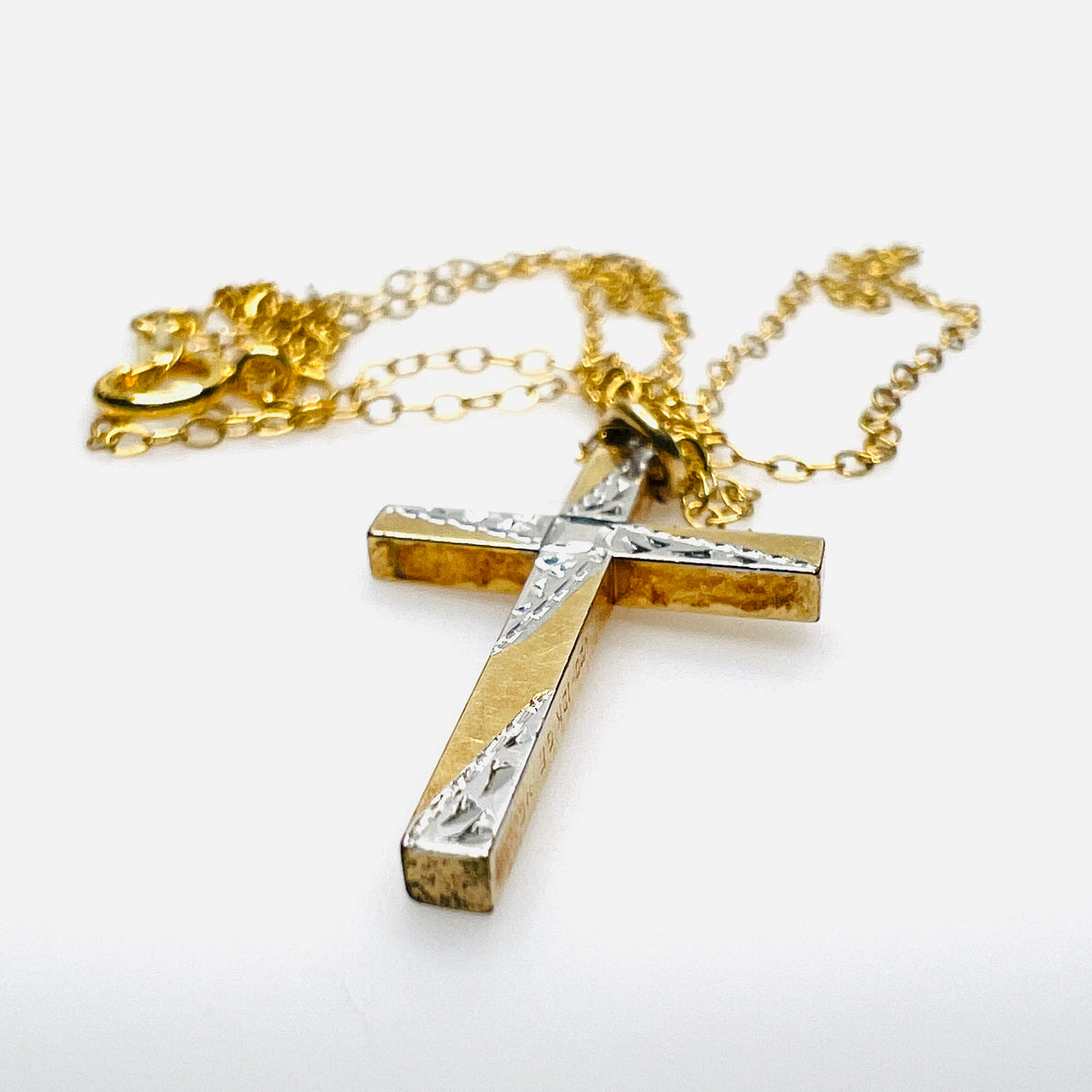 Side view of vintage Carl-Art gold-filled cross pendant and delicate chain