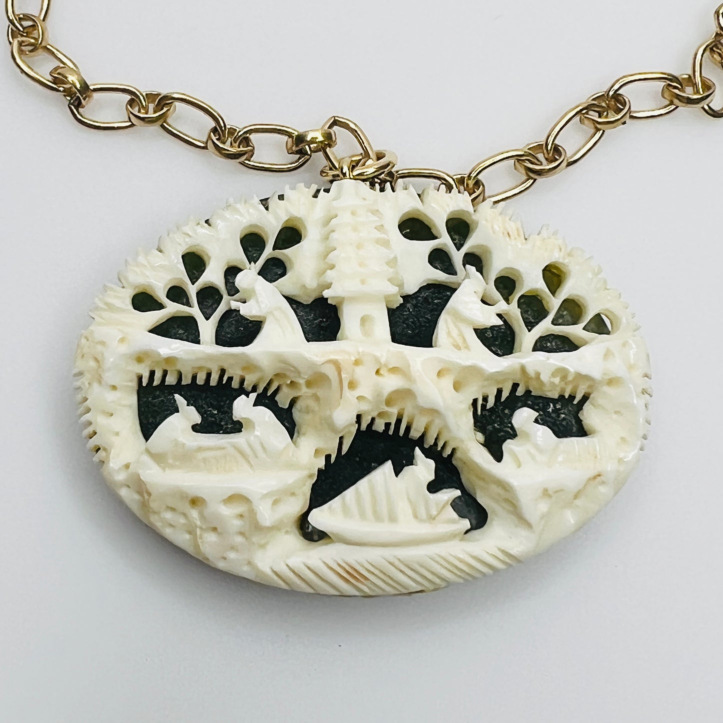 Close-up of ivory bone carving with Chinese motif over green jade