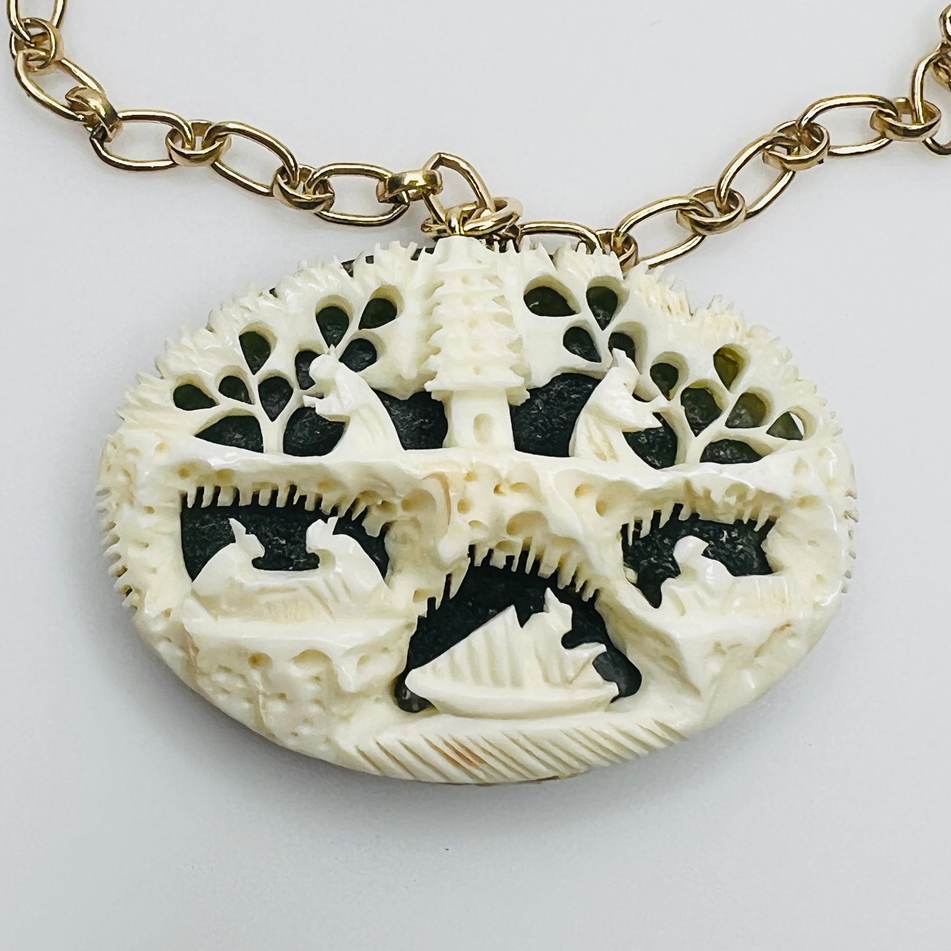 Close-up of ivory bone carving with Chinese motif over green jade