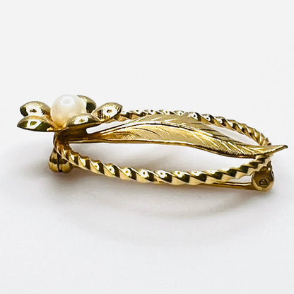 Side view of 1950s gold filled floral brooch with raised genuine pearl