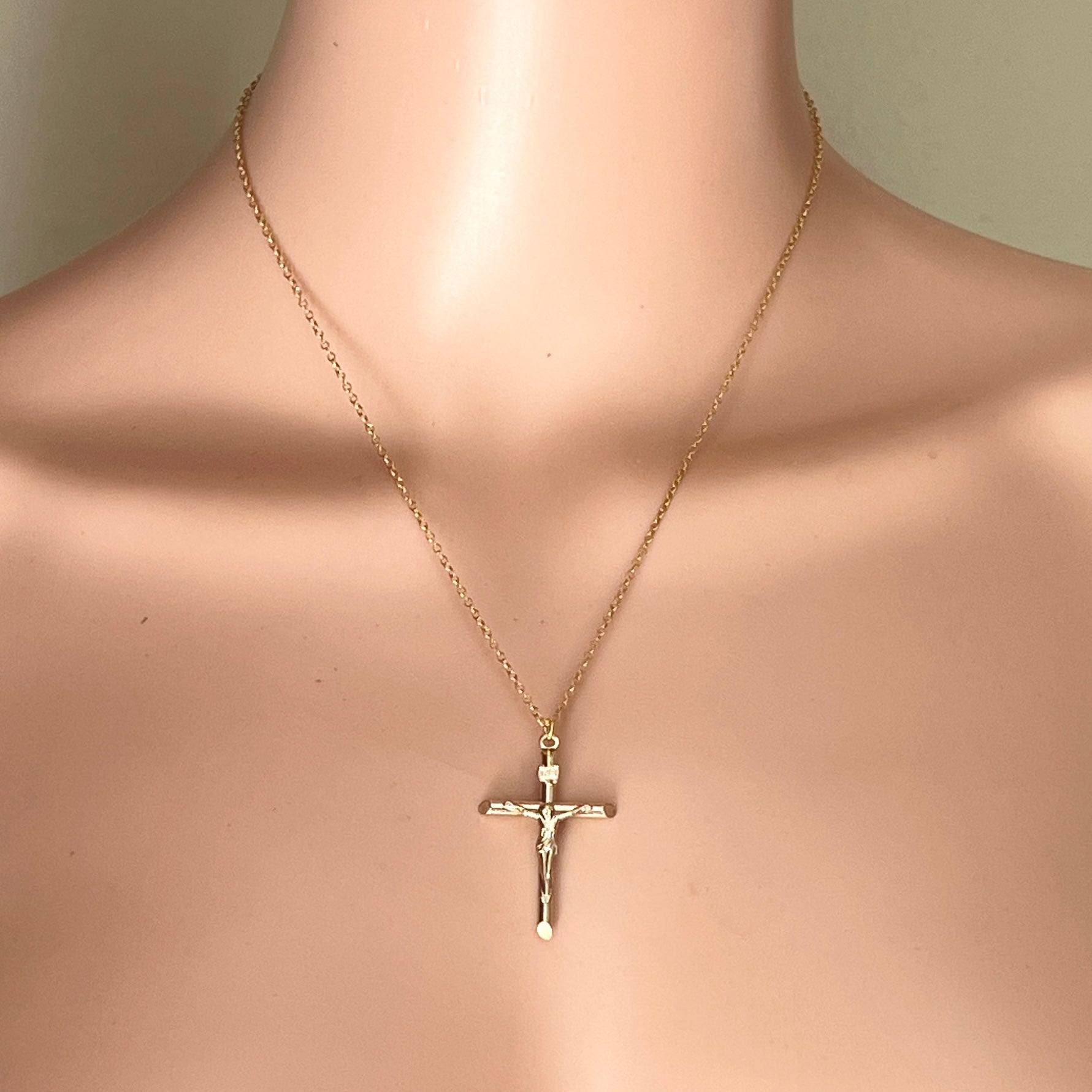 Vintage gold filled crucifix necklace displayed on mannequin.