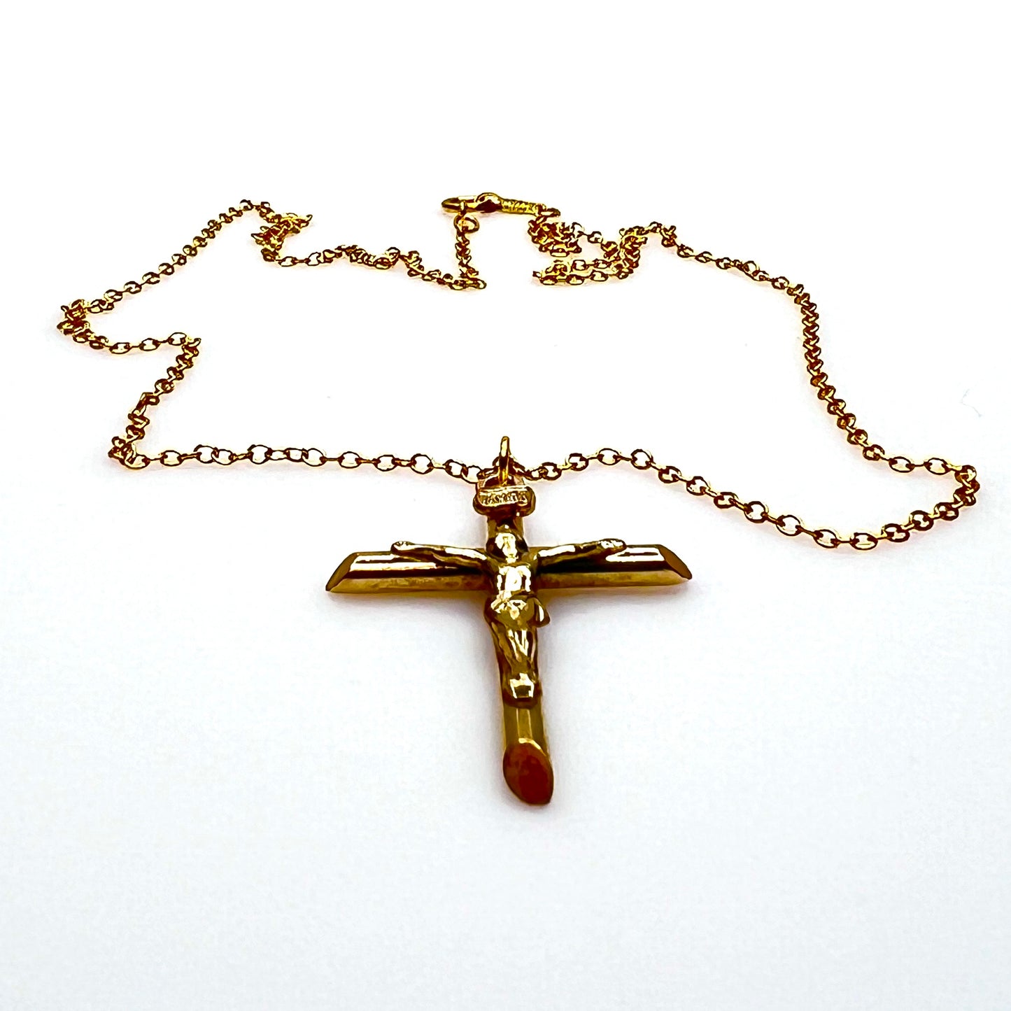 Side view of vintage gold filled crucifix pendant and matching chain.