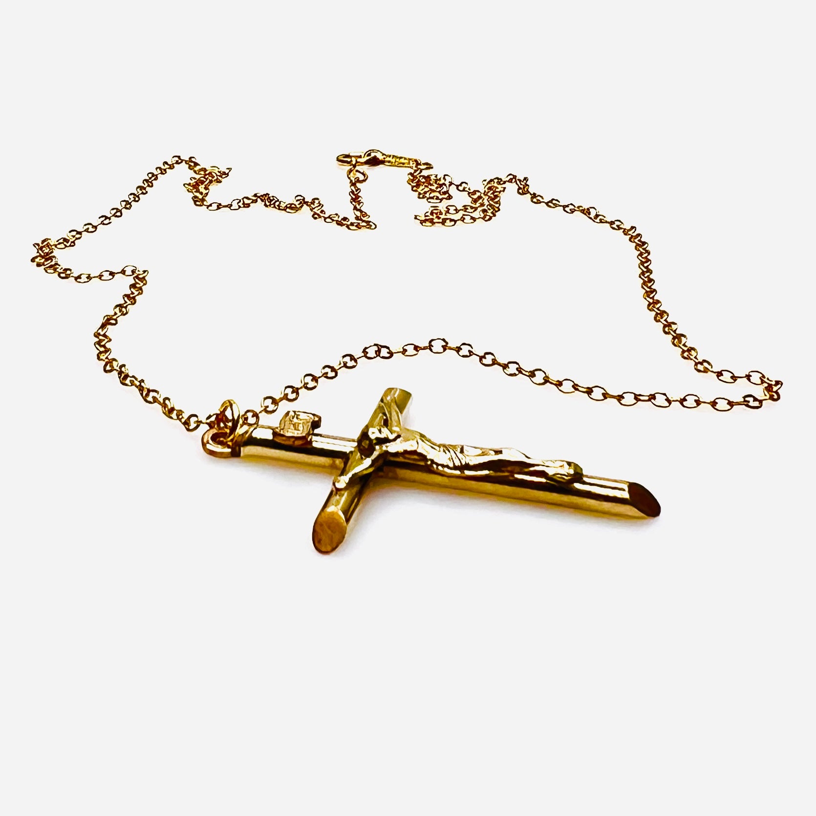 Side view of vintage gold filled crucifix pendant and matching chain.