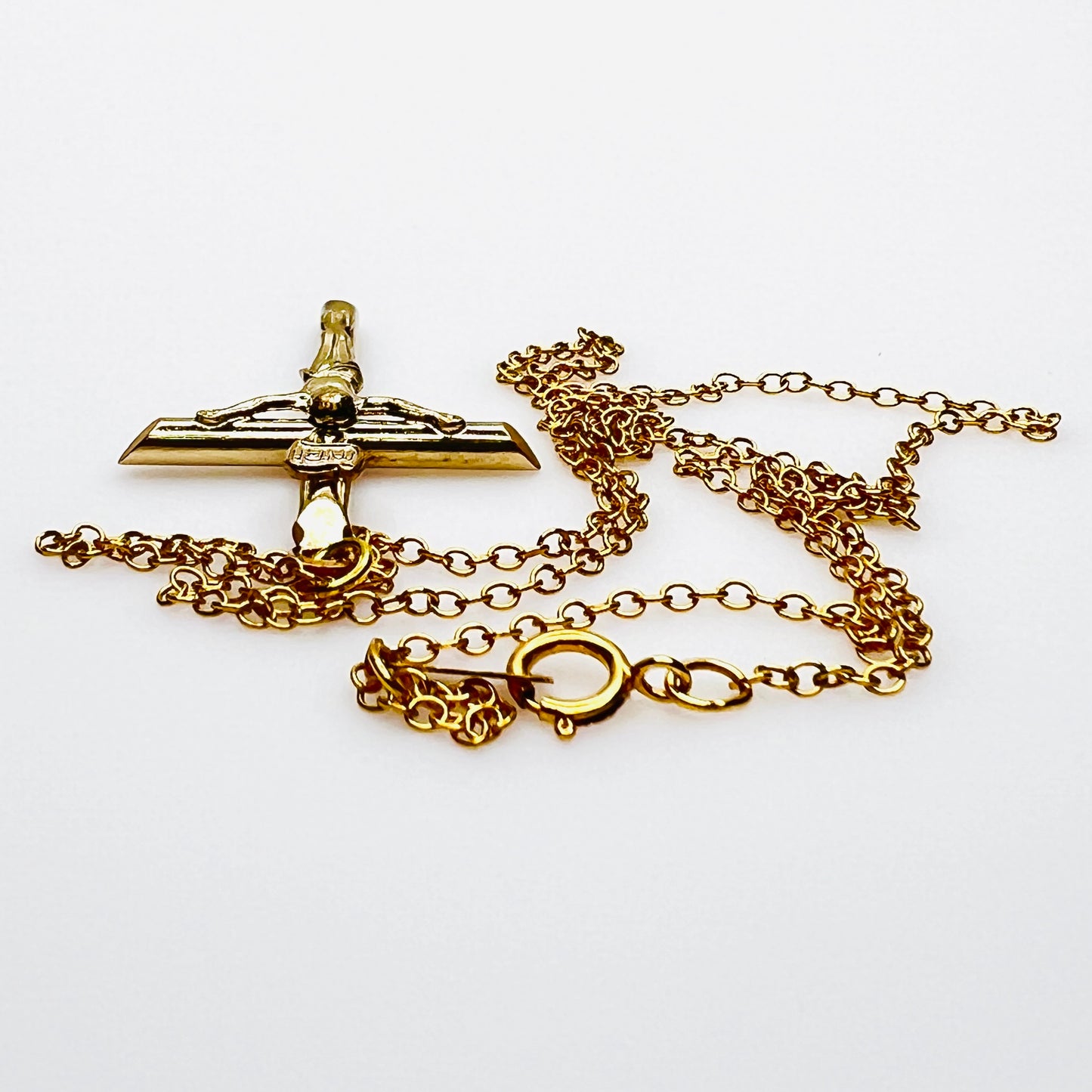 Side view of vintage gold filled crucifix pendant and matching chain.