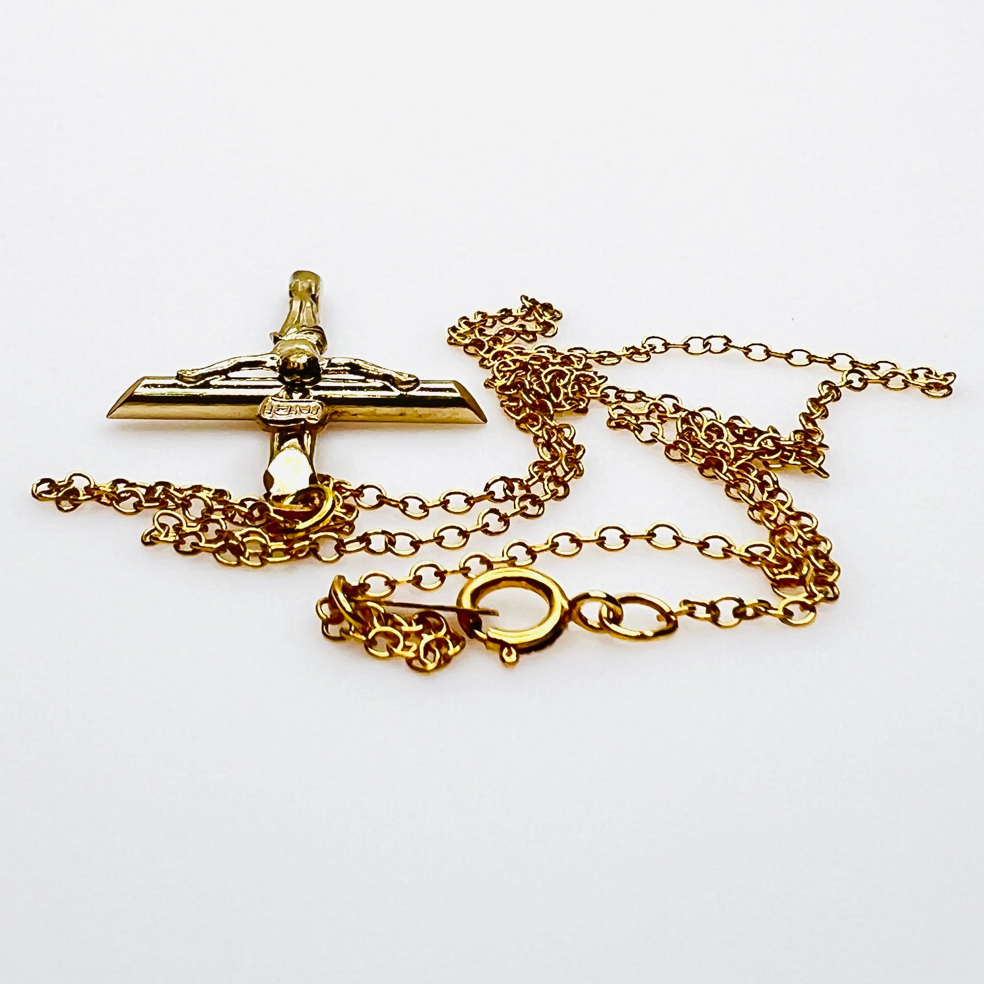 Side view of vintage gold filled crucifix pendant and matching chain.