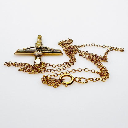 Side view of vintage gold filled crucifix pendant and matching chain.