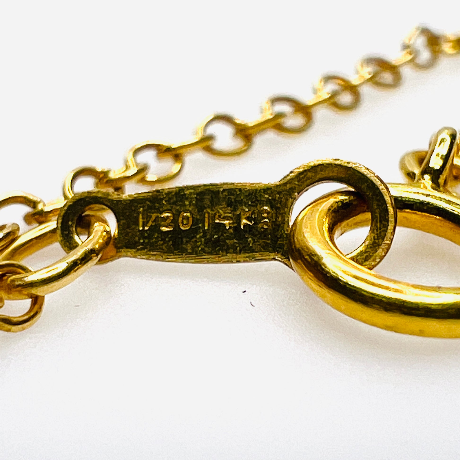 Close-up of 1/20 14K hallmark on gold filled spring ring clasp.