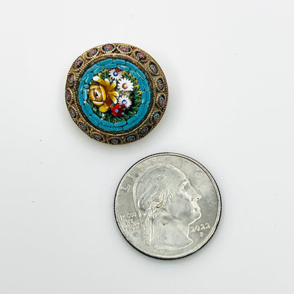Small round Italian floral mosaic brooch beside a quarter, showing its ⅞-inch diameter.