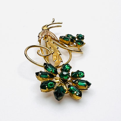 Side view of dimensional 12K gold filled floral brooch with green glass rhinestones