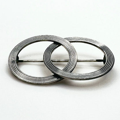 Side view of vintage Beau sterling silver Modernist brooch showing layered circular construction, dimensional profile and pin mechanism.