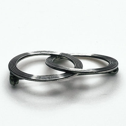 Side view of vintage Beau sterling silver Modernist brooch showing layered circular construction, dimensional profile and pin mechanism.