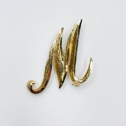 Vintage Mamselle gold tone M or W initial brooch with sculptural curled design