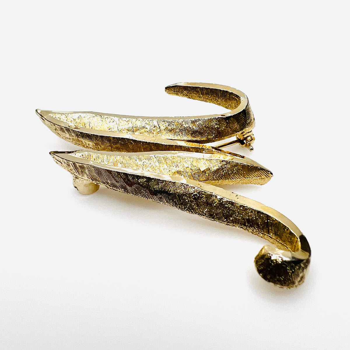 Side view of vintage Mamselle gold tone initial brooch showing dimensional construction