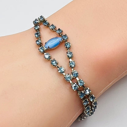 Vintage blue moonstone rhinestone bracelet worn on wrist with gold tone setting