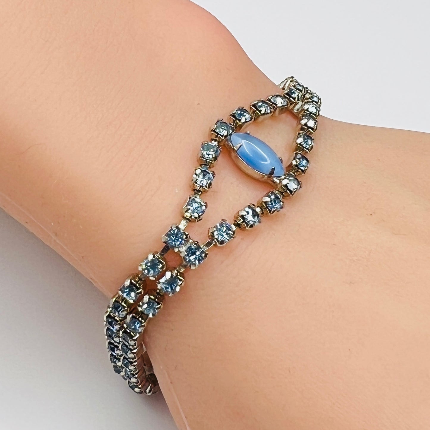 Vintage blue moonstone rhinestone bracelet worn on wrist with gold tone setting