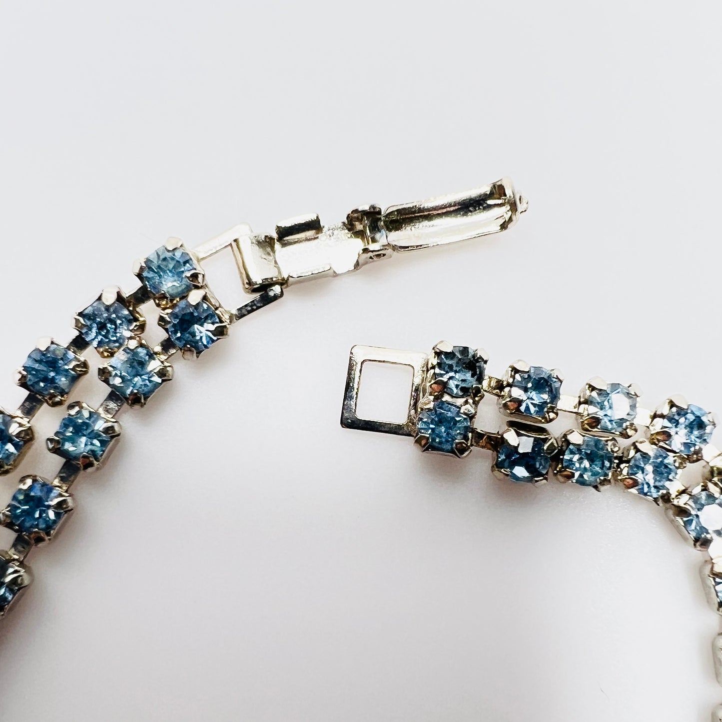 Fold over clasp detail on vintage double strand blue rhinestone bracelet