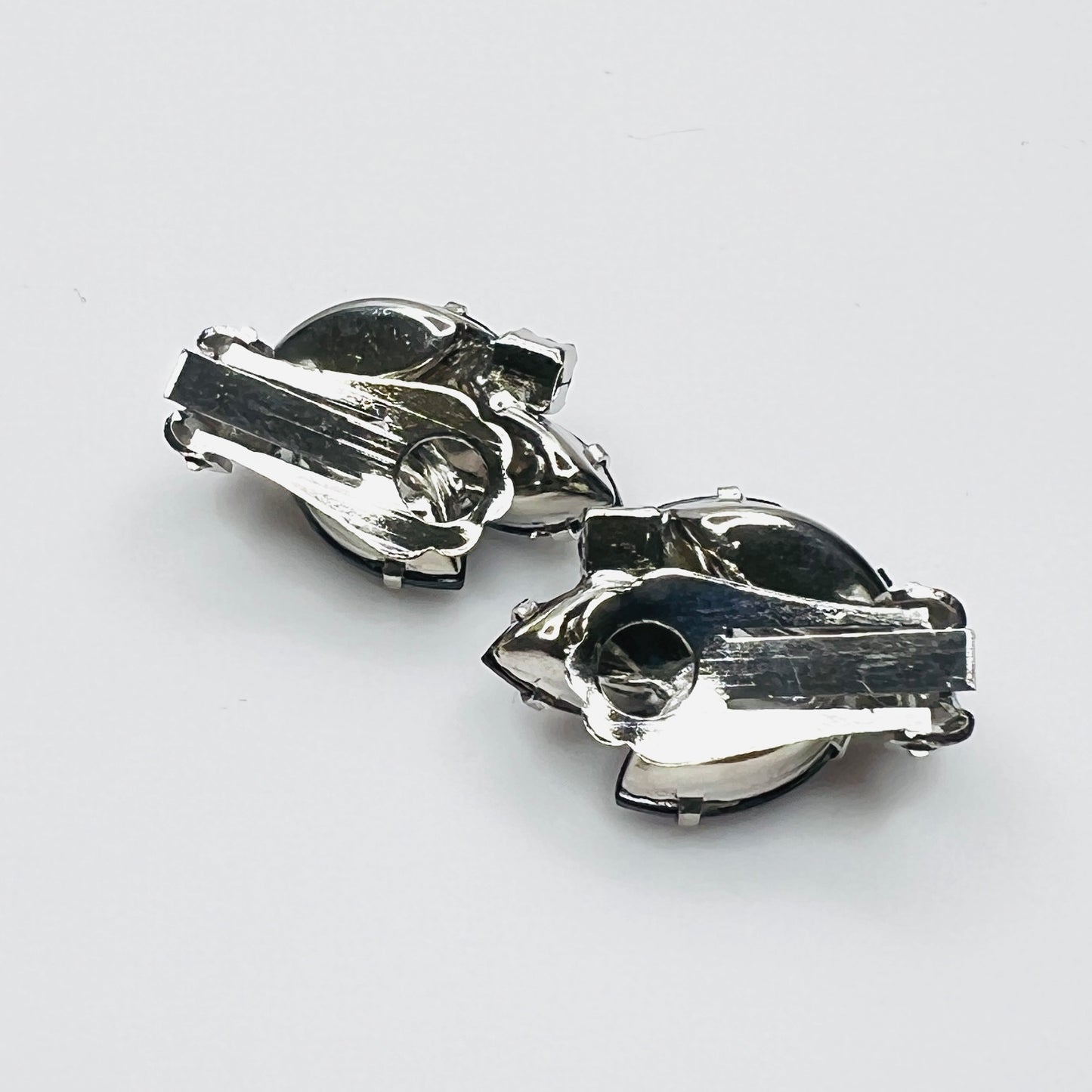 Back of vintage 1950s silver-tone blue rhinestone clip-on earrings.