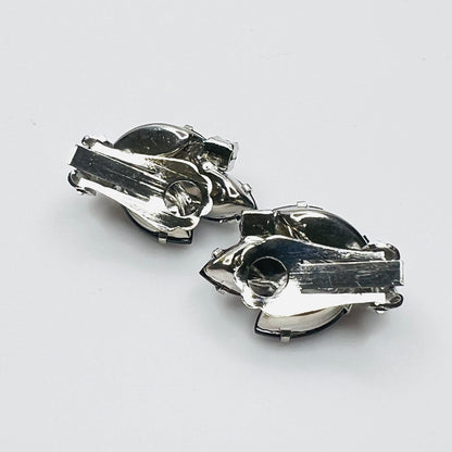 Back of vintage 1950s silver-tone blue rhinestone clip-on earrings.