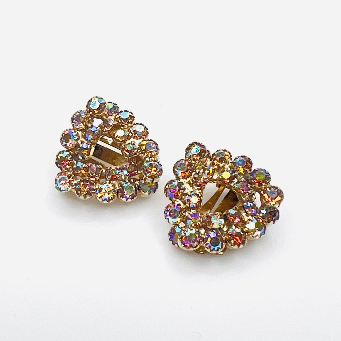 Vintage Continental amber aurora borealis rhinestone clip-on earrings in gold-tone setting.