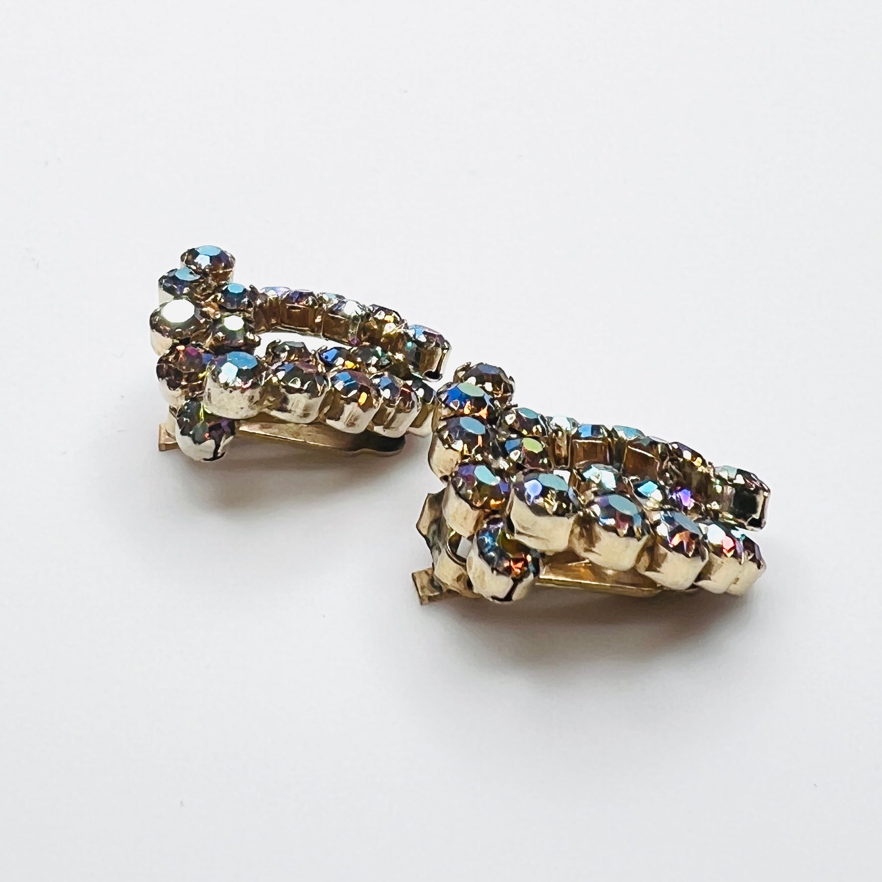 Side view of vintage amber aurora borealis rhinestone clip-on earrings.