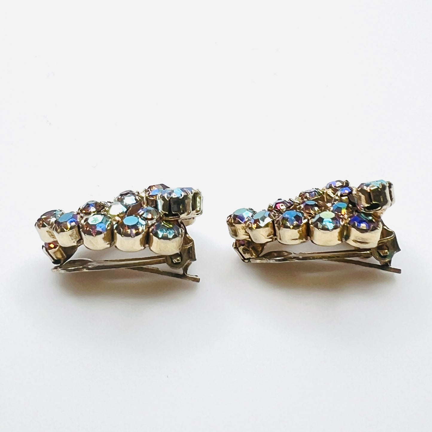 Side view of vintage amber aurora borealis rhinestone clip-on earrings.