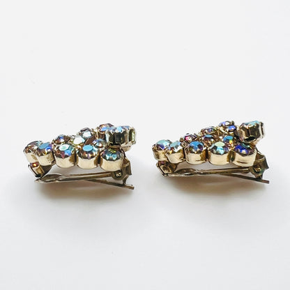 Side view of vintage amber aurora borealis rhinestone clip-on earrings.