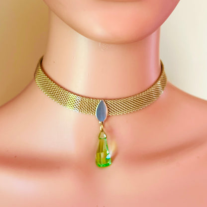 Vintage gold tone mesh choker worn on mannequin with bright green faceted crystal pendant
