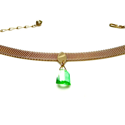 Vintage gold tone mesh choker necklace displayed flat showing green crystal pendant detail