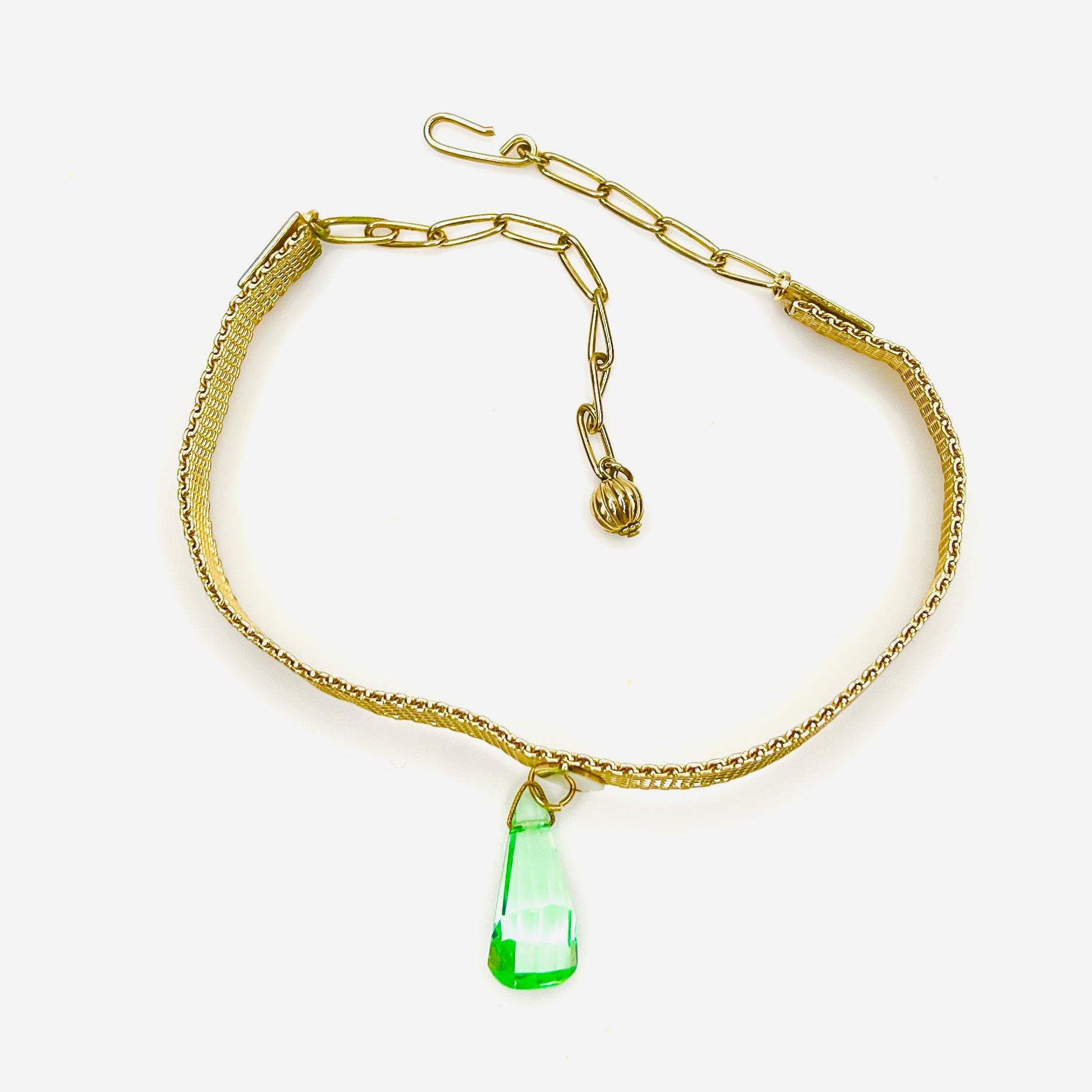 Close-up of vintage 1950s mesh choker necklace with green crystal drop and adjustable chain