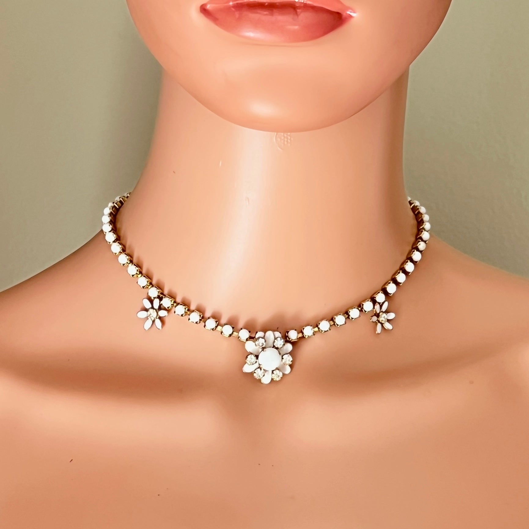 Vintage milk glass rhinestone floral choker displayed on mannequin.