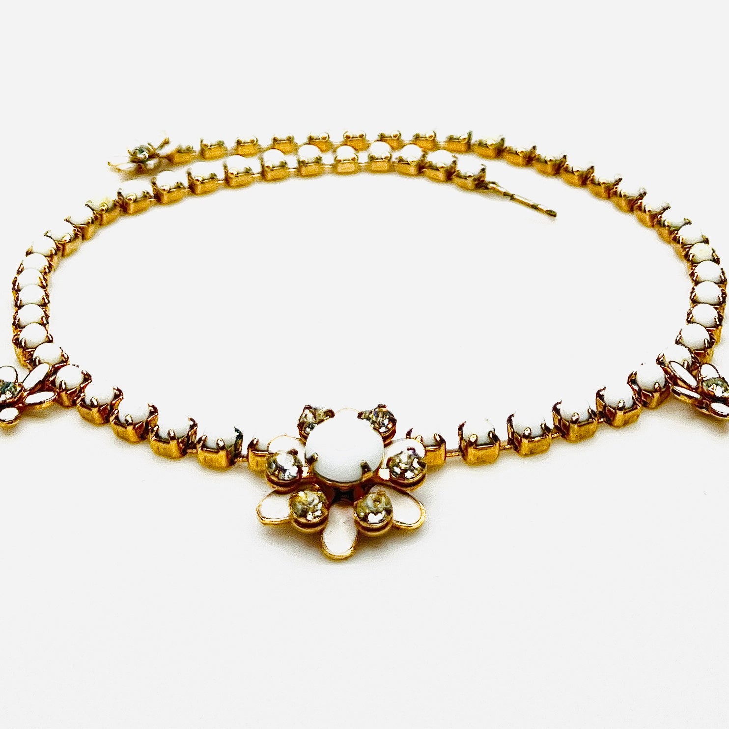 Side view of vintage milk glass and rhinestone floral choker necklace.