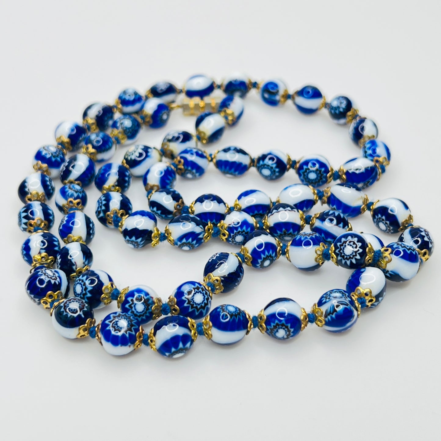 Close up blue millefiori glass beads floral pattern