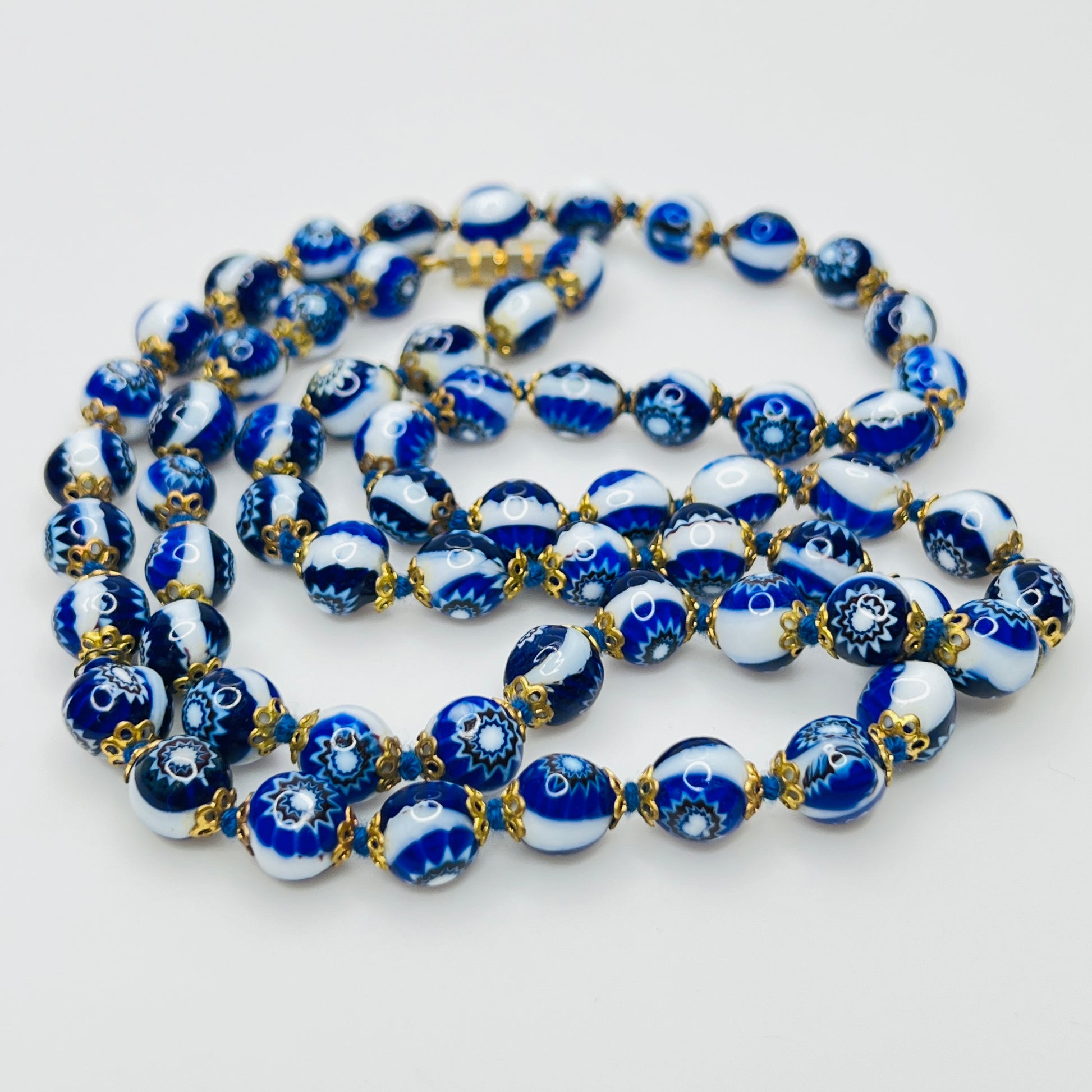 Close up blue millefiori glass beads floral pattern