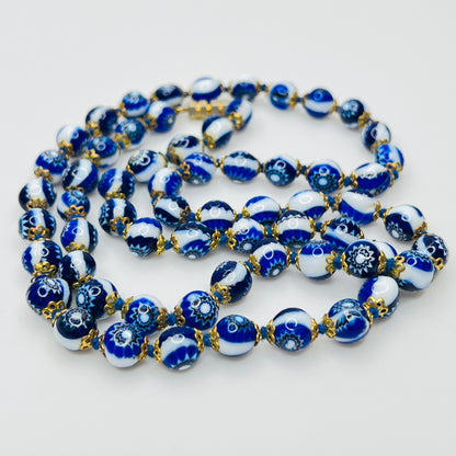 Close up blue millefiori glass beads floral pattern