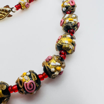Close up of Murano wedding cake beads with gold aventurine detail