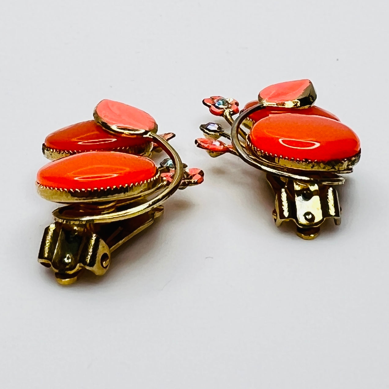 Close-up orange moonglow cabochon enamel leaf rhinestone detail