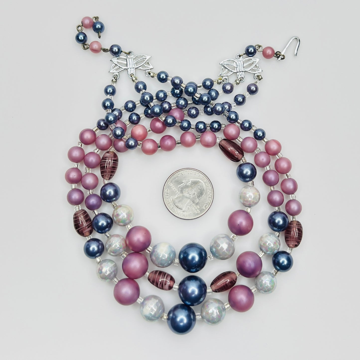 Multi strand necklace with blue pearls and pink beads close up