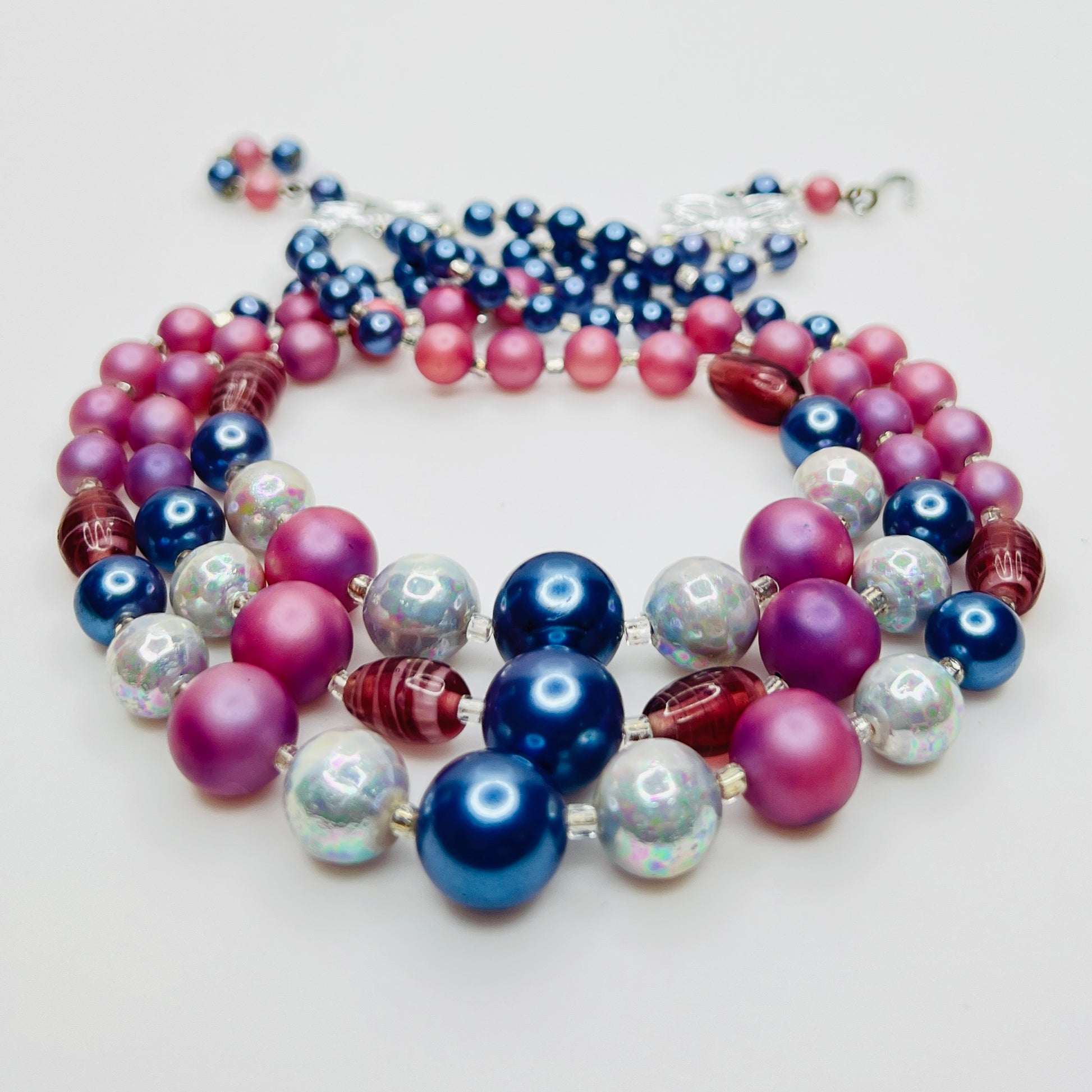 Multi strand necklace with blue pearls and pink beads close up