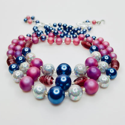 Multi strand necklace with blue pearls and pink beads close up
