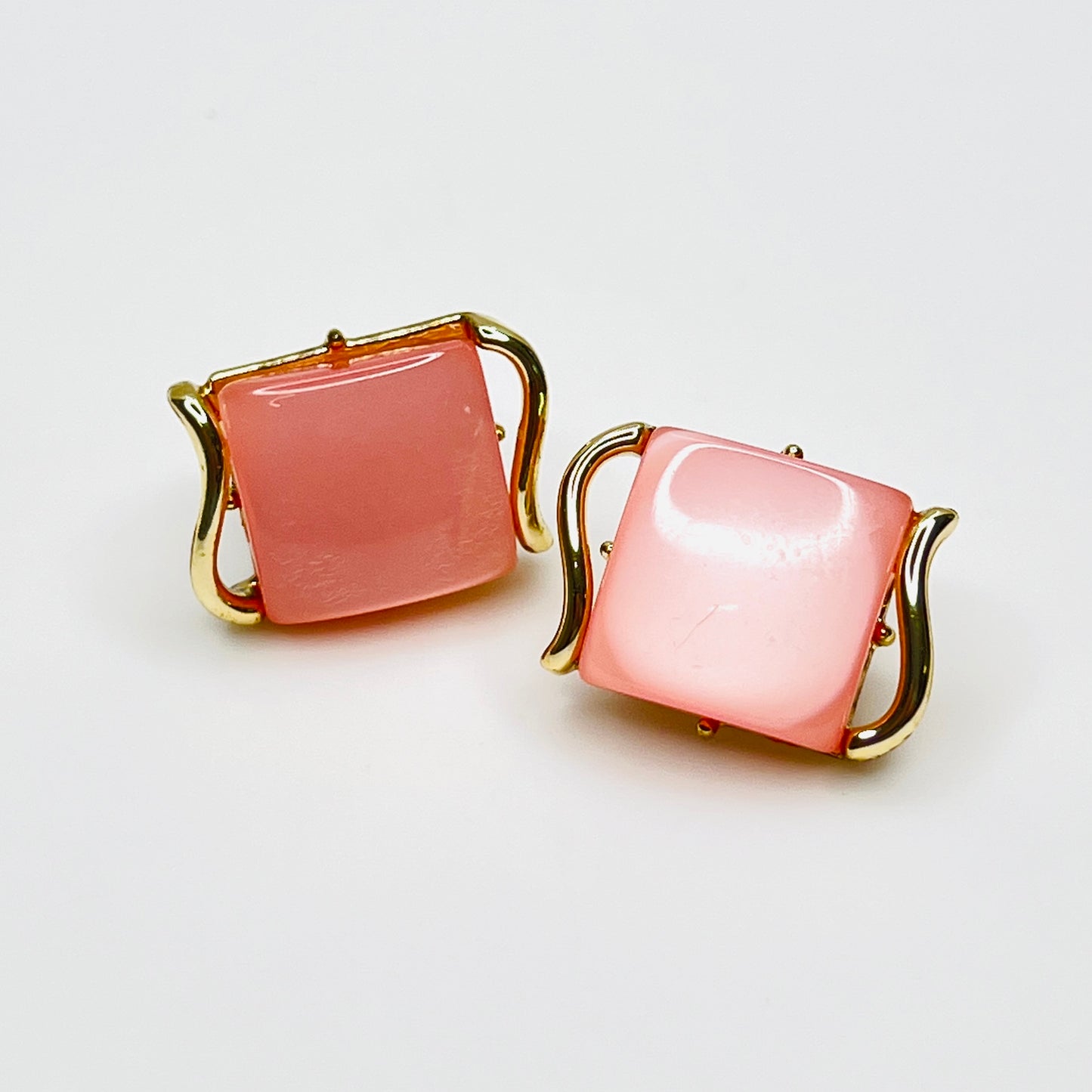 Vintage 1950s pink thermoset Lucite clip-on earrings in gold-tone geometric settings