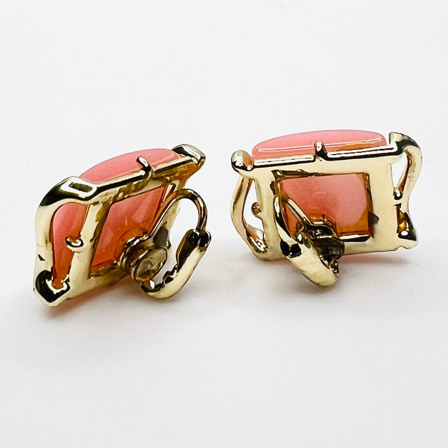 Back view of 1950s pink Lucite clip-on earrings with gold-tone clip closures