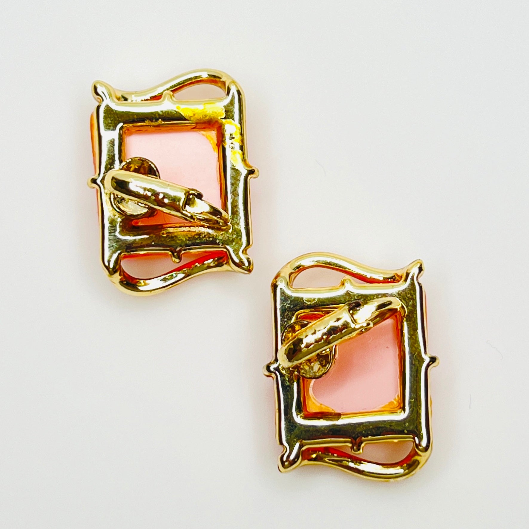 Back view of 1950s pink Lucite clip-on earrings with gold-tone clip closures