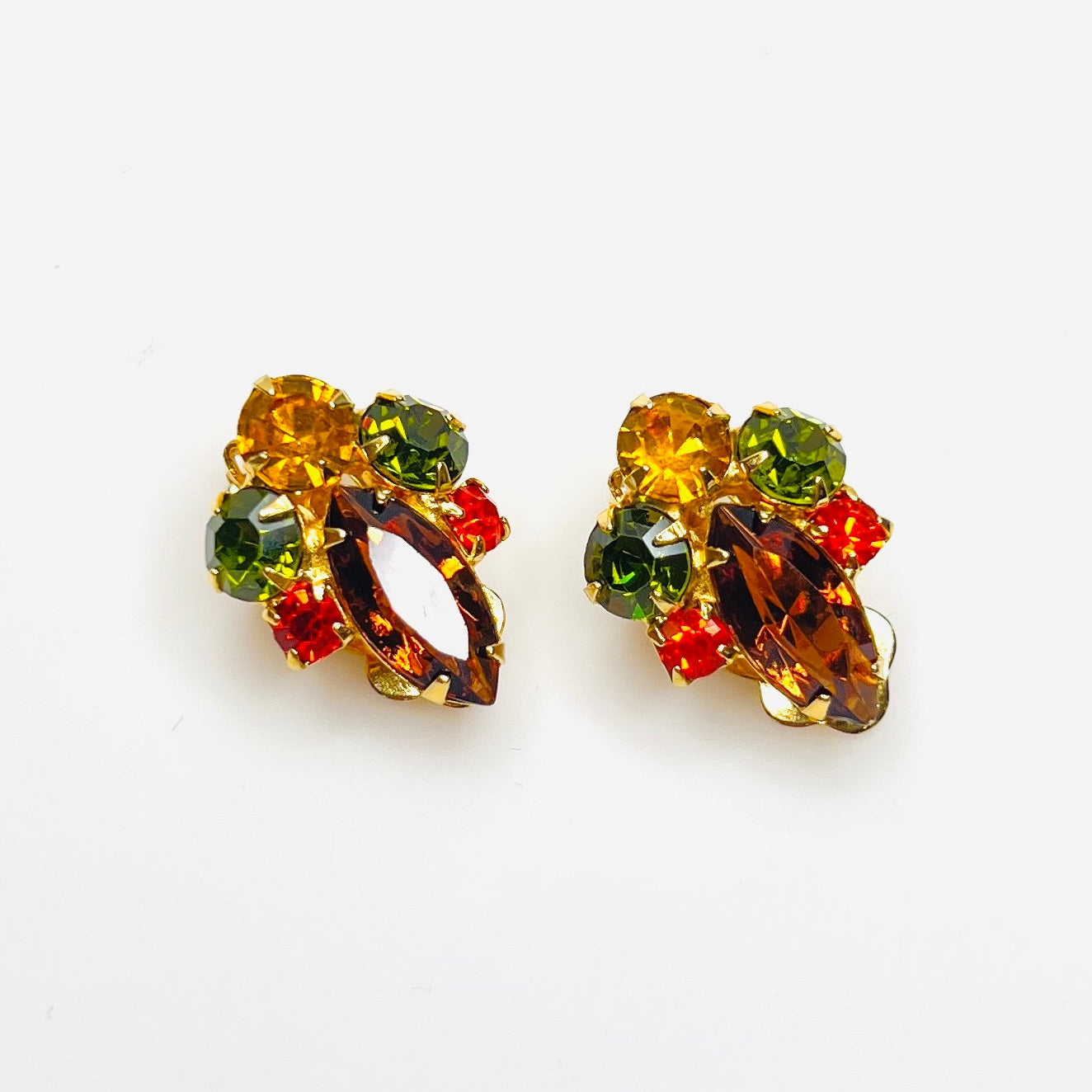 Vintage 1950s autumn rhinestone clip-on earrings with amber green and orange stones.